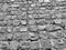 Old paving stones in perspective closeup. Black and white background.