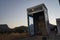 An old payphone booth without a payphone set. A payphone is typically a coin-operated public telephone. Kolympia, Rhodes, Greece