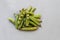 Old peas with open pods sprout on gray background