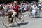 Old people riding Ã©poque bicycles