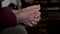 Old Person Hands Are Locked Together And Shaking With Nervous Tic Or Tremor
