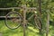 Old person, rusty bicycle , hangs on a wooden beam