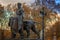 Old photo with one of four bronze statues around the Queen Victoria Memorial, London