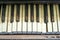 Old piano keyboard aged by time in a public park