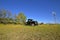 Old pickup sleft in a pasture with sprayer booms extended