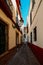 Old picturesque passageway in the medieval Jewish Quarter of Santa Cruz in Seville, Andalusia, Spain