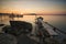 Old Pier, boat and rocks sunset