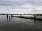 Old pier with drift wood and Wilson bridge in Alexandria, Virginia