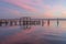 An Old Pier in the Pink Sky of Sunrise