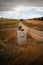 Old pilgrim\'s boot abandoned over a milestone of the Camino de Santiago in the Castilla fields