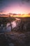 Old pine tree on the edge of a cliff of the river under a beautiful sunset sky