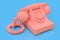 Old pink dial telephone on a blue background. 3d illustration