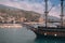 Old pirate ship on the water of Mediteranean sea. Tourist entertainment, coastal tour. Summer sunny day. Mountain shore of Alanya