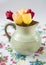 Old pitcher with flowers of tulips