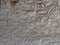 Old plastered stone wall background, rural mediterranean plaster