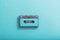 Old plastic cassette on green  background.