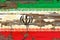 Old plumbed Iran flag on wood.