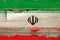 Old plumbed Iran flag on wood.