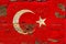 Old plumbed Turkey flag on wood.