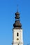 Old Polish catholic church Church of Sts. Maurice tower with clock on the clear blue sky.