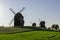 Old Polish windmills and trails from airplanes flying in the sky, Lednogora.