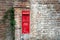 Old postbox on the wall of a house