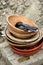 Old pottery plates and wooden bowls on table