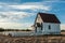 An old prairie church stands in a prairie of New Mexico.