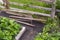 Old primitive mechanical agricultural hand tools near fence on farm