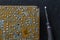 Old printed circuit board background. Vintage circuit board with soldering trace. Backside brown electronic chip retro style