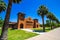 Old Public Park Building With Row Of Palm Trees