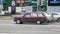 Old purple Lada 2104 in motion. Speeding in city road concept. Obsolete rusty VAZ station wagon