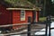 Old quaint vintage wood cabin in the forest painted red