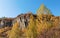 Old quarry. Rocks and yellow trees