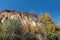 Old quarry. Rocks and yellow trees