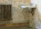 Old radiator and sink in an empty historic home