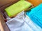 Old rags and eco-friendly cleaning cloths neatly arranged in a cardboard box. Old rags and things for cleaning and