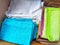 Old rags and eco-friendly cleaning cloths neatly arranged in a cardboard box. Old rags and things for cleaning and