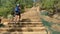 The old railroad ties that make up the Manitou Incline hike in Colorado. Woman hiker climbs the stairs