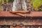 Old railroad track with two large and rusty rail nails