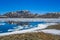 Old rails lead into water of frozen lake Vavatn Hemsedal