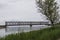 Old railway bridge over the river. Boat with fishermen on the water