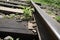 Old railway in the countryside. Fastening the rails to the sleeper with a nail