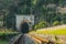 Old railway passing through an abandoned tunnel in the thickets of a humid forest