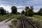 Old railway tracks and gravel leading into the infinite distance with selective focus