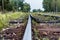 Old railway tracks and gravel leading into the infinite distance with selective focus