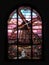 Old Realistic Stained Glass Window with the image of a windmill - pink tones