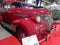 Old red 1939 Chevrolet Chevy Master coupe by GM. Exhibit hall. Chromes. Grille. Classic car show