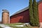 Old red barn in early winter with just a touch of snow on a sunny day on a farm