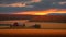 Old Red Barn on Hay Field at Sunrise with Bales of Hay.